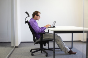 Image of man sitting and slouching in bad posture