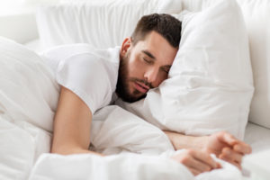 image of man on pillow that is too high