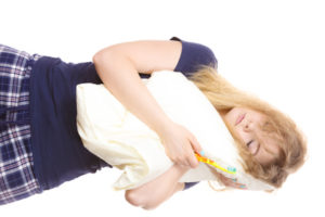 Image of woman side sleeping on pillow.
